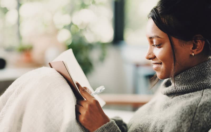 Woman writing in notebook